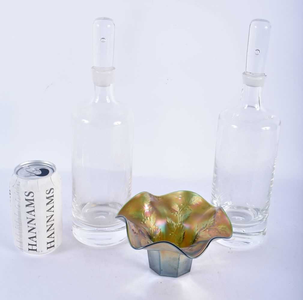 A PAIR OF RETRO GLASS DECANTERS AND STOPPERS together with an iridescent glass bowl. Largest 30cm