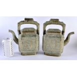 A LARGE PAIR OF 19TH CENTURY INDIAN BRONZE TEAPOTS AND COVERS decorated with floral sprays and