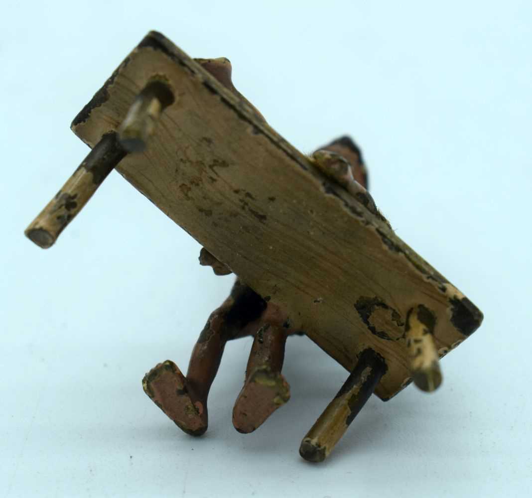 A VERY RARE ANTIQUE COLD PAINTED BRONZE TRIBAL BEATING FIGURE. 22.3 grams. 3.5 cm x 3.5 cm. - Image 3 of 3