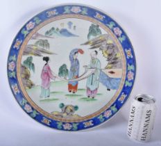 A 19TH CENTURY JAPANESE MEIJI PERIOD PORCELAIN PLATE painted with three figures. 34 cm diameter.