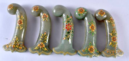 A SET OF FIVE MIDDLE EASTERN QAJAR LACQUER HARDSTONE DAGGER HANDLES overlaid with foliage and vines.