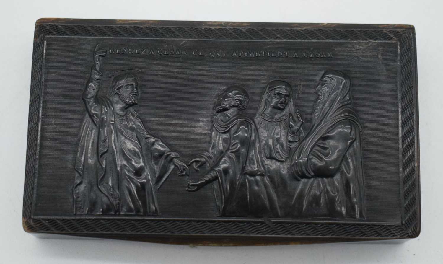 A 19TH CENTURY CARVED HORN SNUFF BOX AND COVER depicting four saints within a landscape. 9.5 cm x