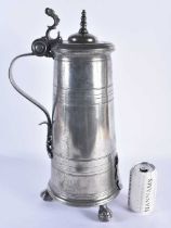 A LARGE ANTIQUE ARMORIAL PEWTER FLAGON bearing 1704 date to top. 48 cm high.