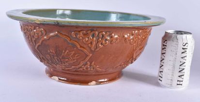 A LARGE CHINESE REPUBLICAN PERIOD BROWN GLAZED POTTERY BOWL decorated with foliage. 34 cm x 14 cm.