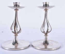 A STYLISH PAIR OF ART NOUVEAU SILVER PLATED CANDLESTICKS. 15 cm high.