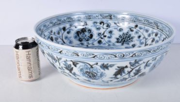 A large Chinese porcelain blue and white bowl decorated with foliage 15 x 40 cm.