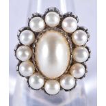 A Silver and Pearl Ring. The central Pearl is surrounded by 12 smaller pearls. Size Q, Stamped