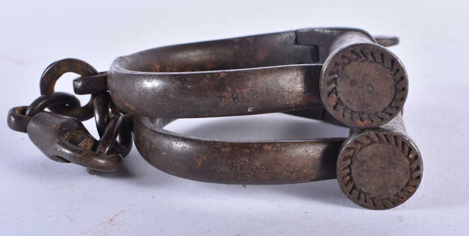 A PAIR OF ANTIQUE HANDCUFFS together with a similar padlock. Largest 24 cm long. (3) - Image 7 of 7