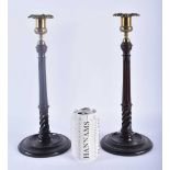 A PAIR OF EDWARDIAN MAHOGANY CANDLESTICKS. 34 cm high.