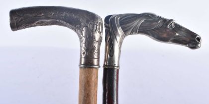 AN ANTIQUE SILVER HANDLED WALKING CANE together with a similar horse head cane. 90 cm long. (2)