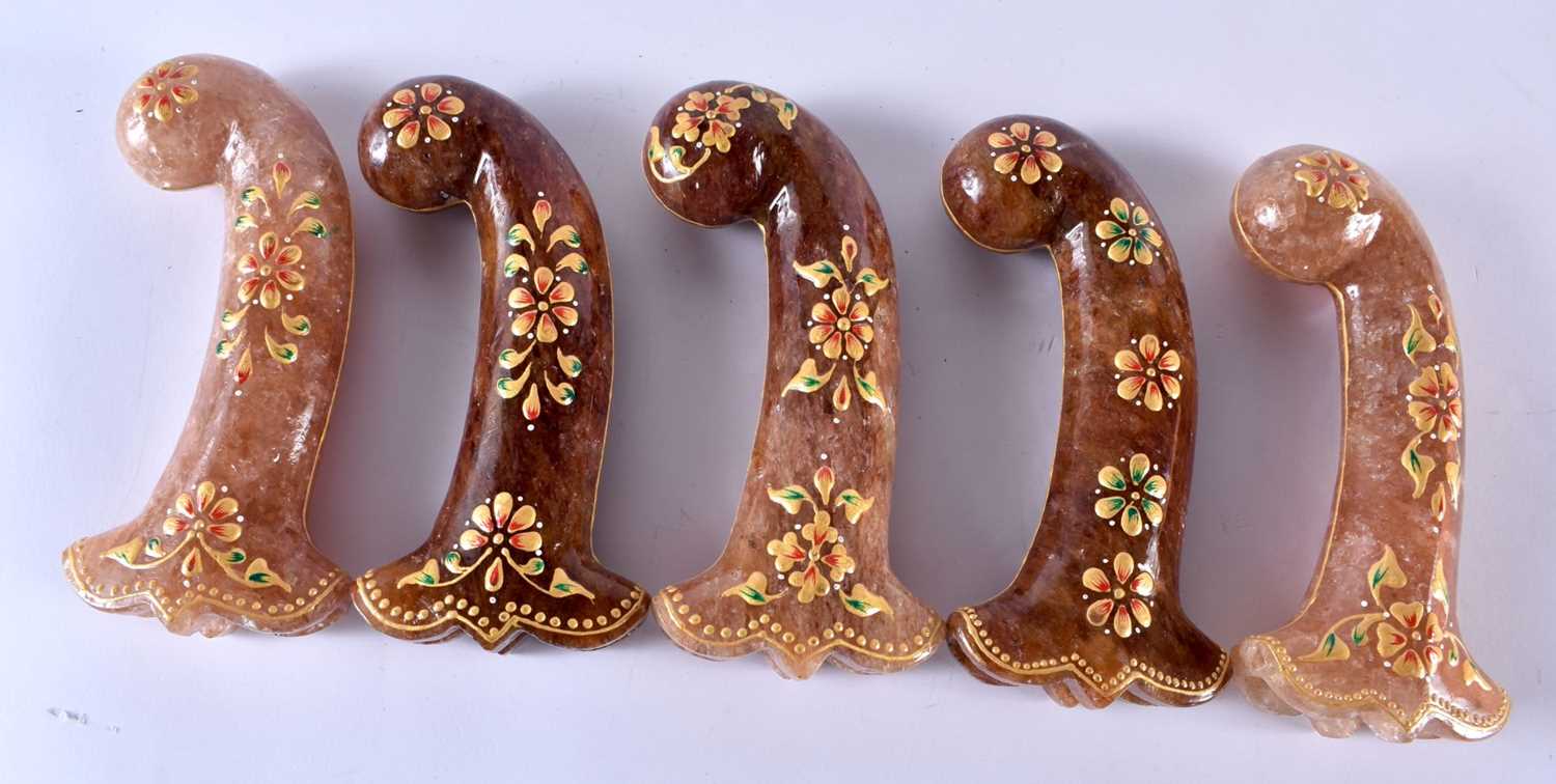 A SET OF FIVE MIDDLE EASTERN QAJAR LACQUER HARDSTONE DAGGER HANDLES overlaid with foliage and vines.