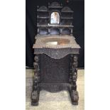 A 19th Century Anglo Indian/Burmese carved hardwood Davenport 136 x 64 x 69 cm..