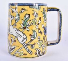 A MIDDLE EASTERN FAIENCE IZNIK JERUSALEM POTTERY MUG painted with leaping deer. 12 cm x 10 cm.