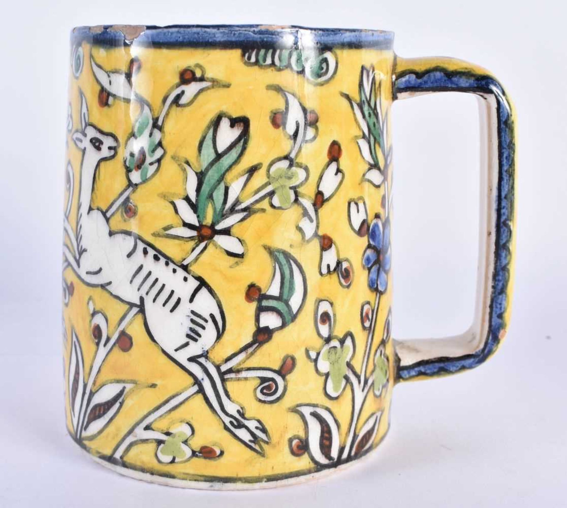 A MIDDLE EASTERN FAIENCE IZNIK JERUSALEM POTTERY MUG painted with leaping deer. 12 cm x 10 cm.