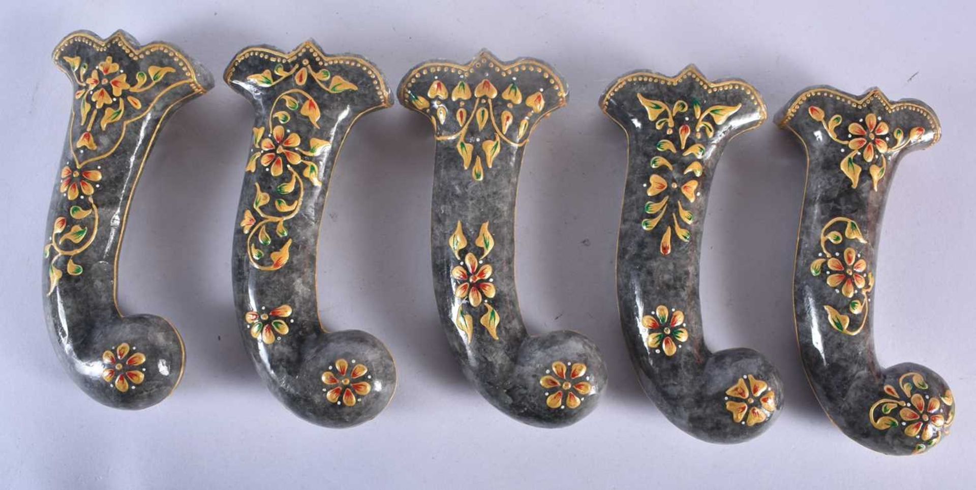 A SET OF FIVE MIDDLE EASTERN QAJAR LACQUER HARDSTONE DAGGER HANDLES overlaid with foliage and vines. - Image 2 of 3