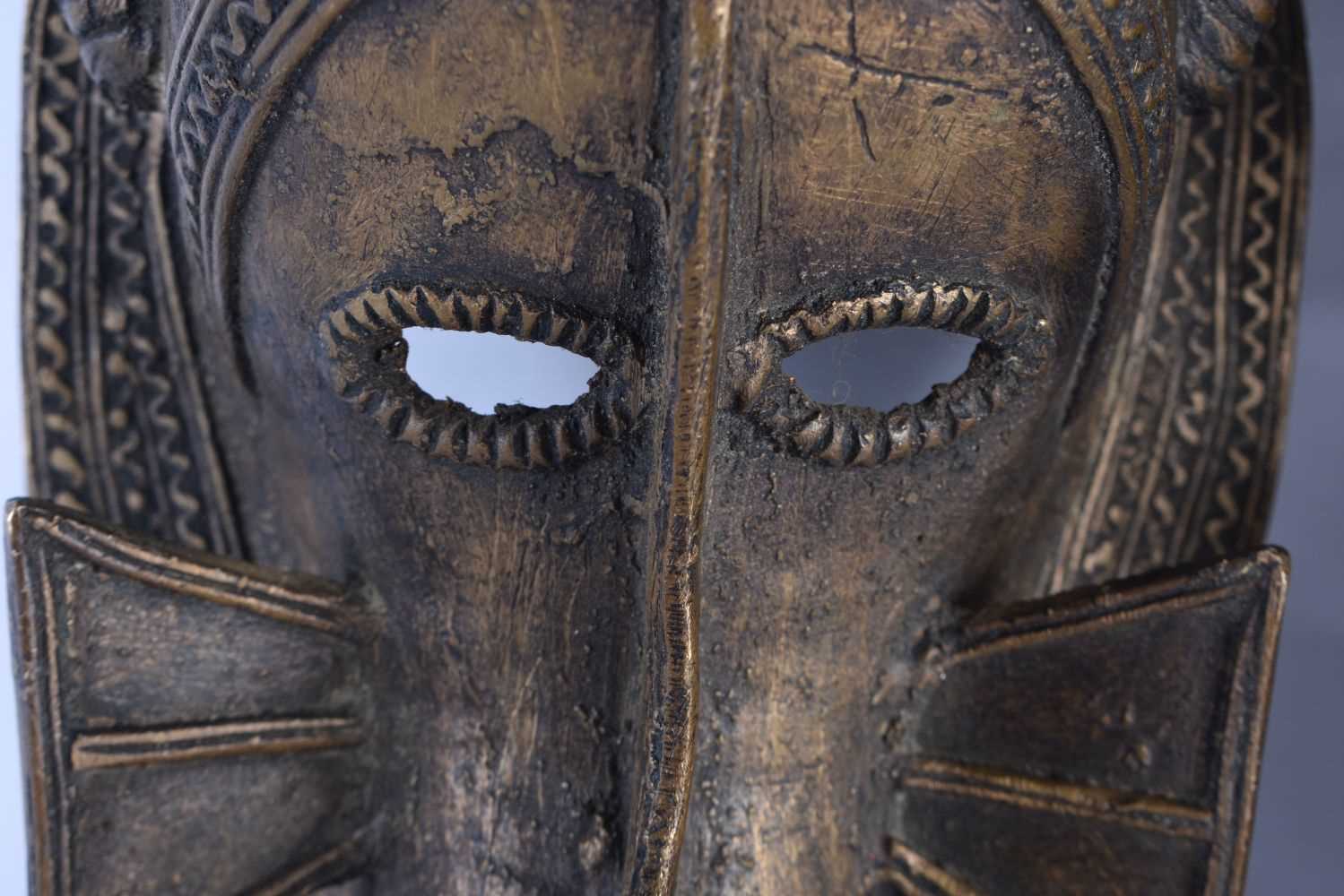 A PAIR OF AFRICAN BRONZE TRIBAL MASKS. 35 cm x 10 cm. - Image 2 of 5