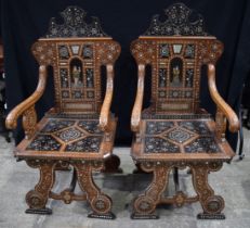 A pair of 19th Century Walnut Italian Chairs in the style of Adriano Brambilla lavishly inlaid