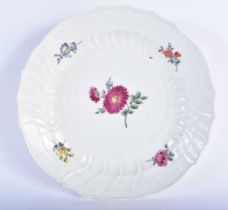 AN 18TH/19TH CENTURY MEISSEN SCALLOPED PORCELAIN PLATE painted with flowers. 22 cm wide.