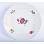 AN 18TH/19TH CENTURY MEISSEN SCALLOPED PORCELAIN PLATE painted with flowers. 22 cm wide.