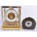 A LECOULTRE BRASS ATMOS CLOCK together with a smaller Cornish stone desk barometer. Largest 24 cm