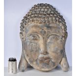 A pottery Buddhas head 56 x 40 cm