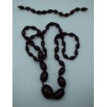 A CHERRY AMBER TYPE NECKLACE. 54 grams. 76 cm long.