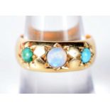 An 18 Carat Gold Ring set with Three Opals. Stamped 18K, Size O, weight 7.5g