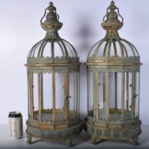 A pair of Islamic style metal and glass lanterns 61 cm (2).
