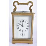 AN ANTIQUE FRENCH REPEATING BRASS CARRIAGE CLOCK. 17 cm high including handle.