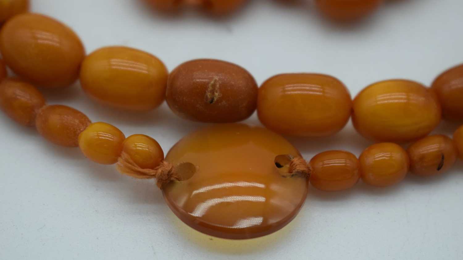 AN AMBER AND AGATE NECKLACE. 41 grams. 82 cm long. Largest amber bead 1.75 cm x 0.75 cm. - Image 3 of 3