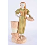 Royal Worcester blush ivory and shot enamel figure of a girl carrying a basket of grapes shape