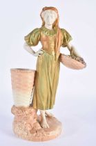 Royal Worcester blush ivory and shot enamel figure of a girl carrying a basket of grapes shape