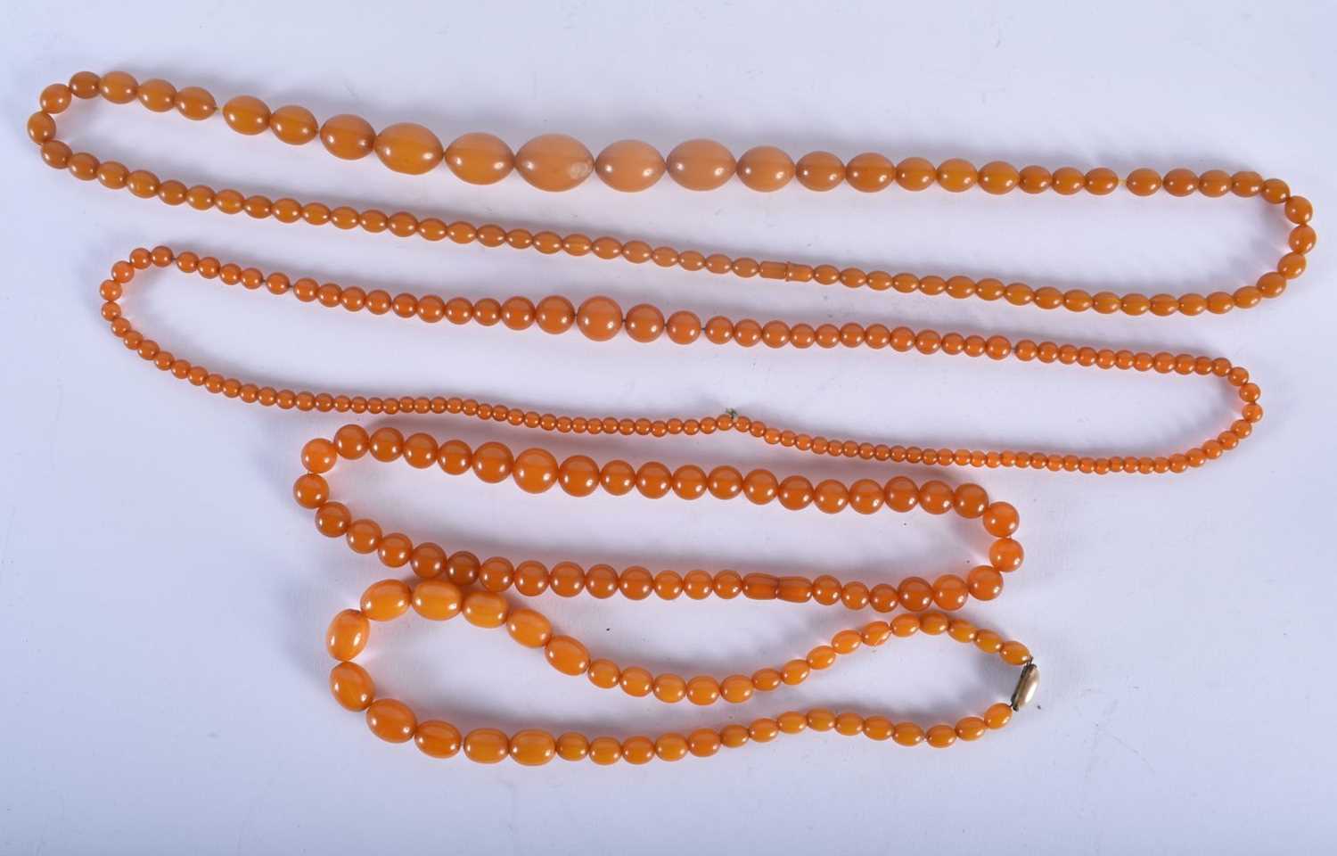 FOUR VINTAGE AMBER TYPE NECKLACES. 183 grams. Largest 88 cm long. (4)