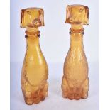 A PAIR OF ART DECO SMOKEY AMBER GLASS DOG DECANTERS AND STOPPERS. 23 cm high.