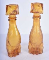 A PAIR OF ART DECO SMOKEY AMBER GLASS DOG DECANTERS AND STOPPERS. 23 cm high.