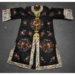 A CHINESE REPUBLICAN PERIOD SILK EMBROIDERED ROBE decorated with figures and foliage. 110 cm x 120