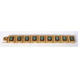 A 14 Carat Gold Panel Bracelet set with Jade Cabochons. Stamped 14K, 16.5 cm x 2.1cm, weight 60.4g