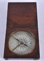 A Compass in a Wooden Case. 9cm x 9cm