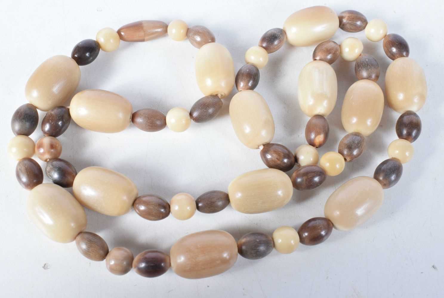 A 19TH CENTURY CHINESE CARVED BLOND RHINOCEROS HORN PRAYER BEAD NECKLACE Qing. 96 grams. 80 cm long,