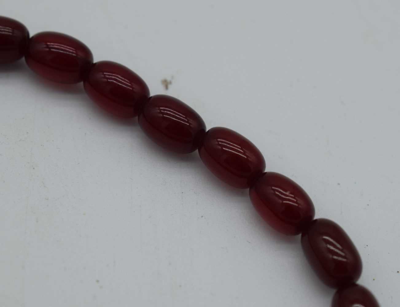 A CHERRY AMBER NECKLACE. 54 grams. 76 cm long, largest bead 2.5 cm x 1.75 cm. - Image 3 of 6