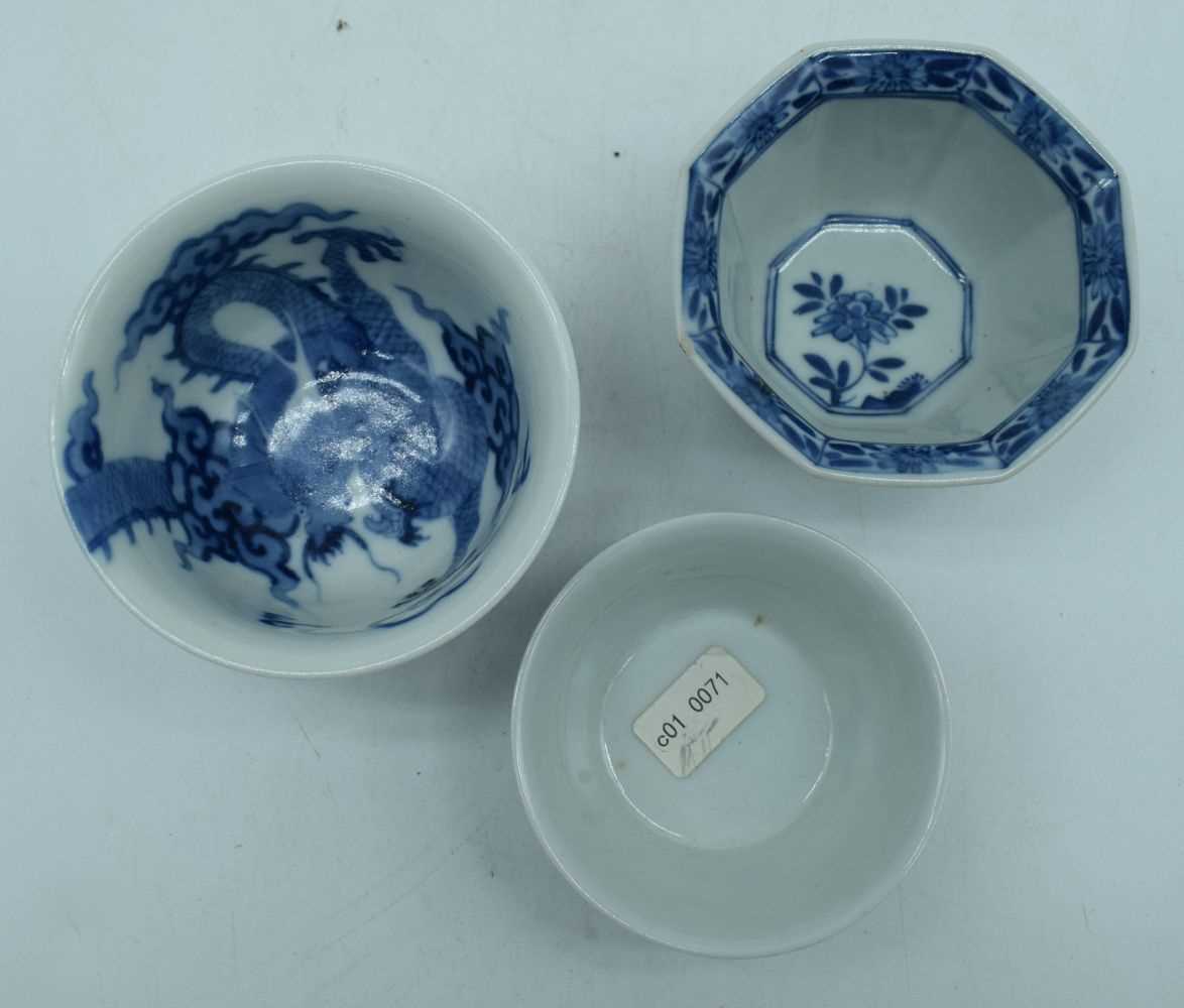 A small Chinese porcelain blue and white dragon bowl with two small bowls 6 x 9 cm. (3) - Image 3 of 6