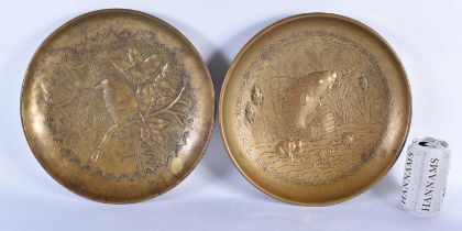 A LARGE PAIR OF ARTS AND CRAFTS BRASS REPOUSSE DISHES depicting carp and birds amongst foliage. 30cm