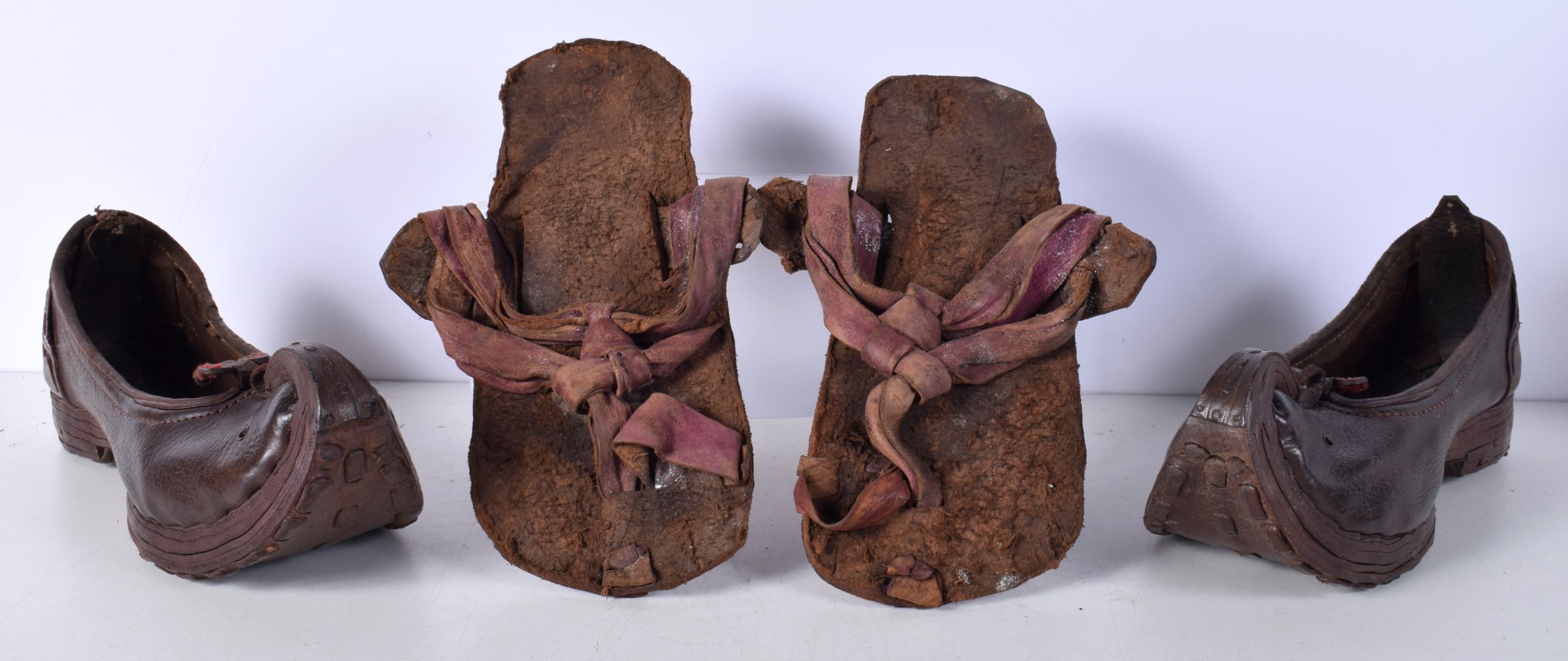 A pair of antique Central Asian leather shoes and a pair leather sandals