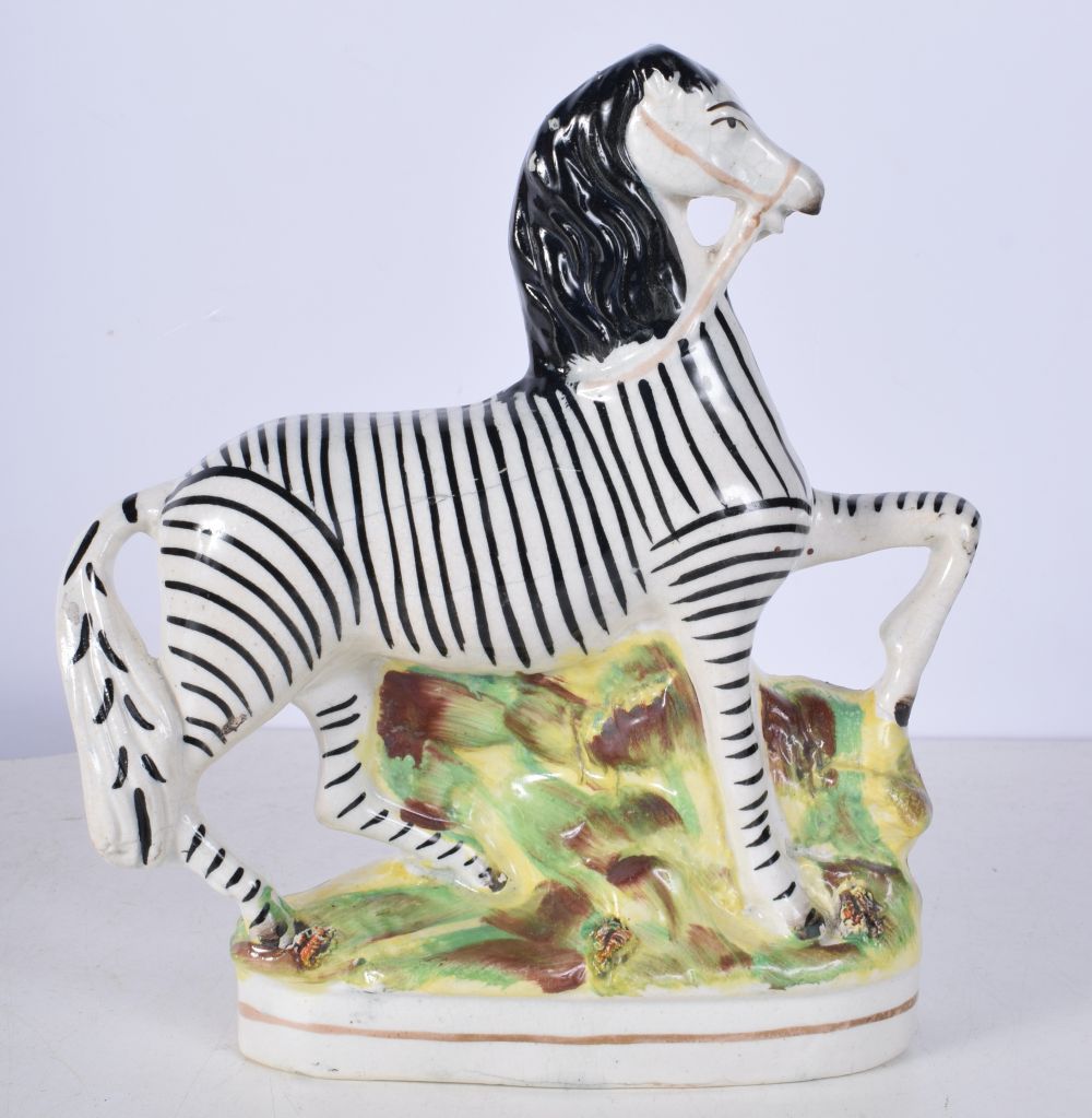 A 19th Century Staffordshire flatback figure of a Zebra together with a Tom King figure 23 cm (2). - Image 7 of 8