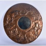 A RARE ART DECO COPPER REPOUSSE COUNTRY HOUSE MIRROR depicting a pack of lions within a landscape.