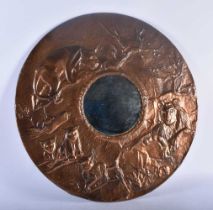 A RARE ART DECO COPPER REPOUSSE COUNTRY HOUSE MIRROR depicting a pack of lions within a landscape.