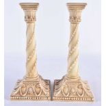 A PAIR OF ROYAL WORCESTER BLUSH IVORY CANDLESTICKS. 27 cm high.