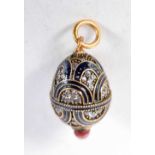 A Continental Silver Gilt and Enamel Egg Pendant. Stamped 84. 2.6 cm x 1.5 cm, weight 5.8g