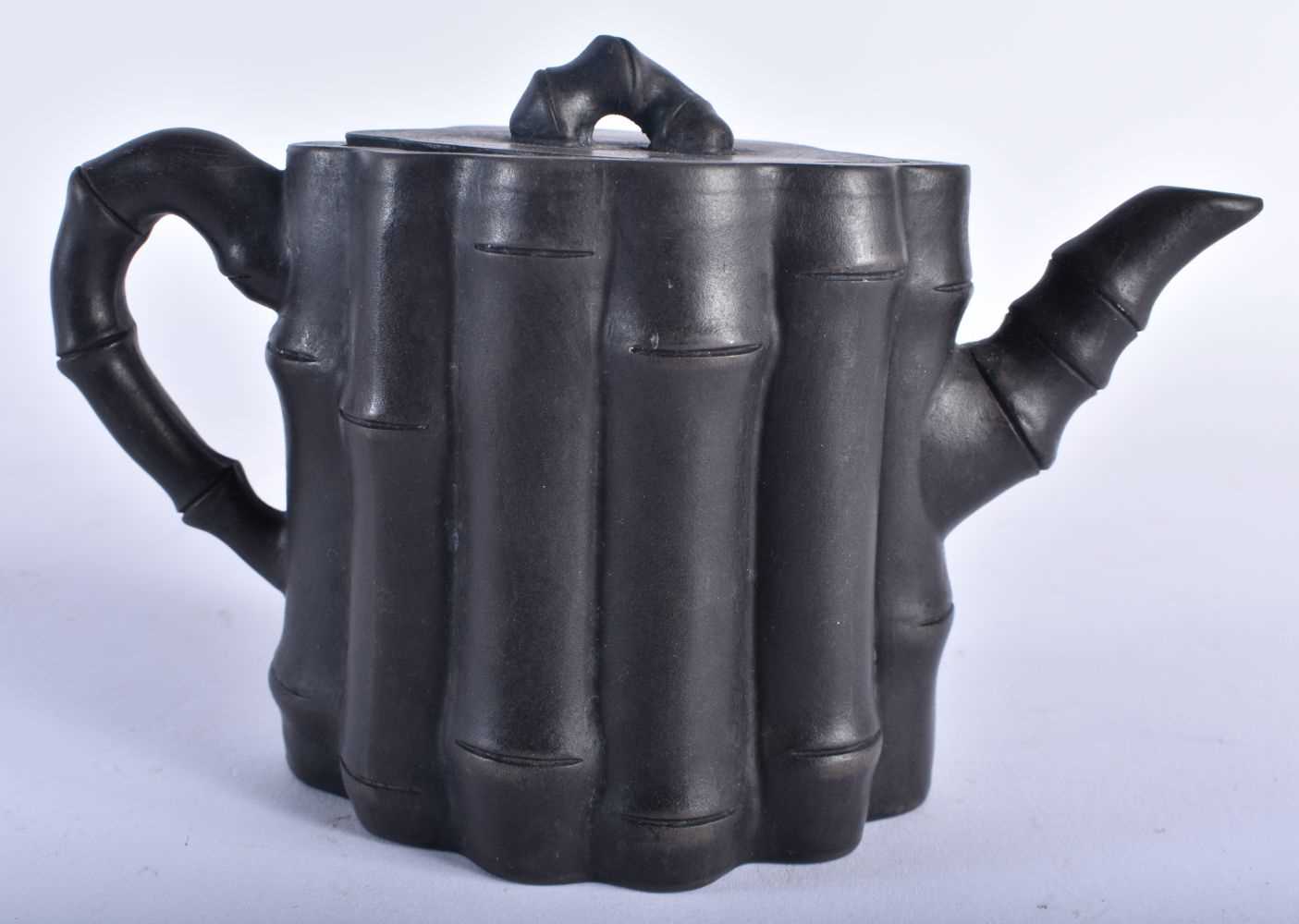 A CHINESE YIXING POTTERY TEAPOT AND COVER 20th Century. 15 cm wide.