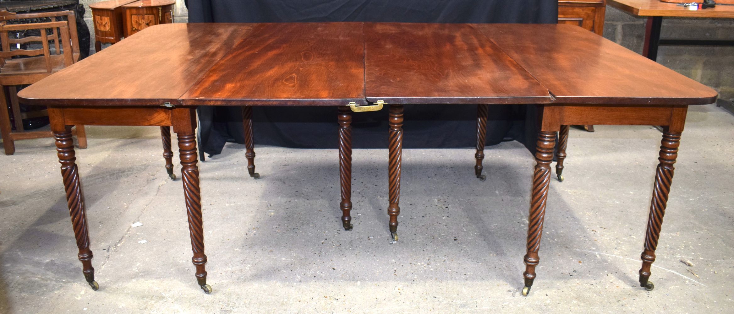 A large antique mahogany two section dining table with two folding centre legs 74 x 201 x 130 cm.